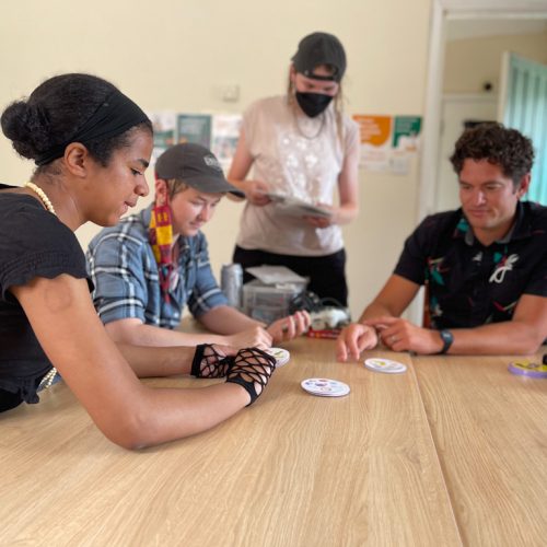 young adults play cards at ESTEEM