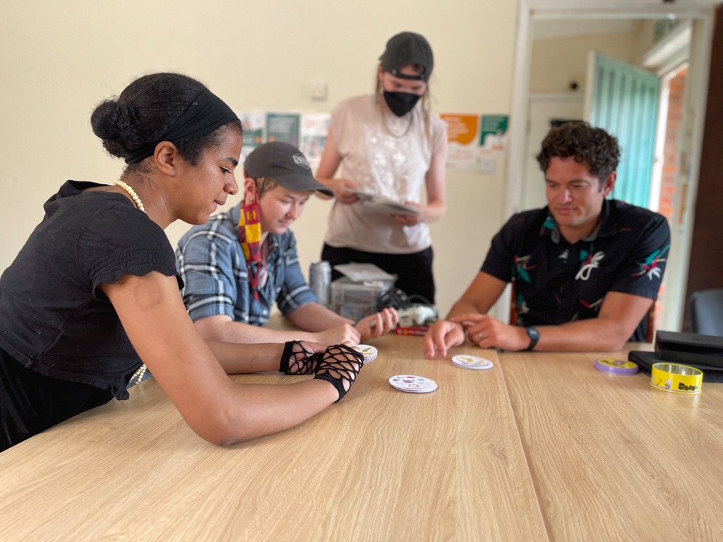 young adults play cards at ESTEEM